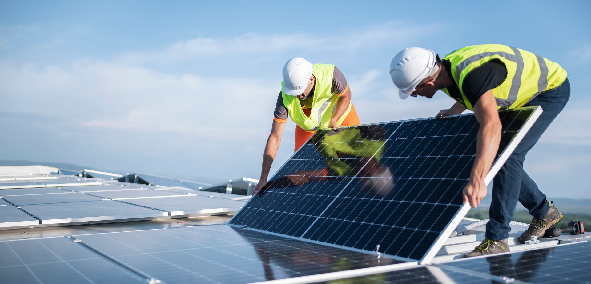 Two technicians setting up solar panels