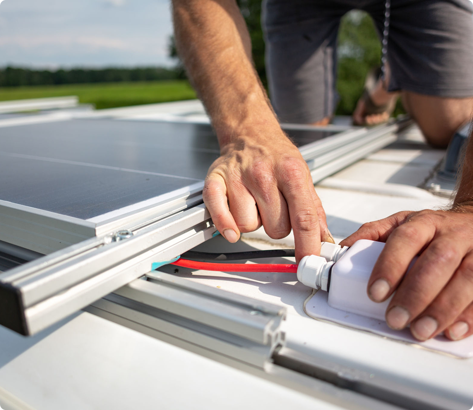 Hands working on solar panel installation