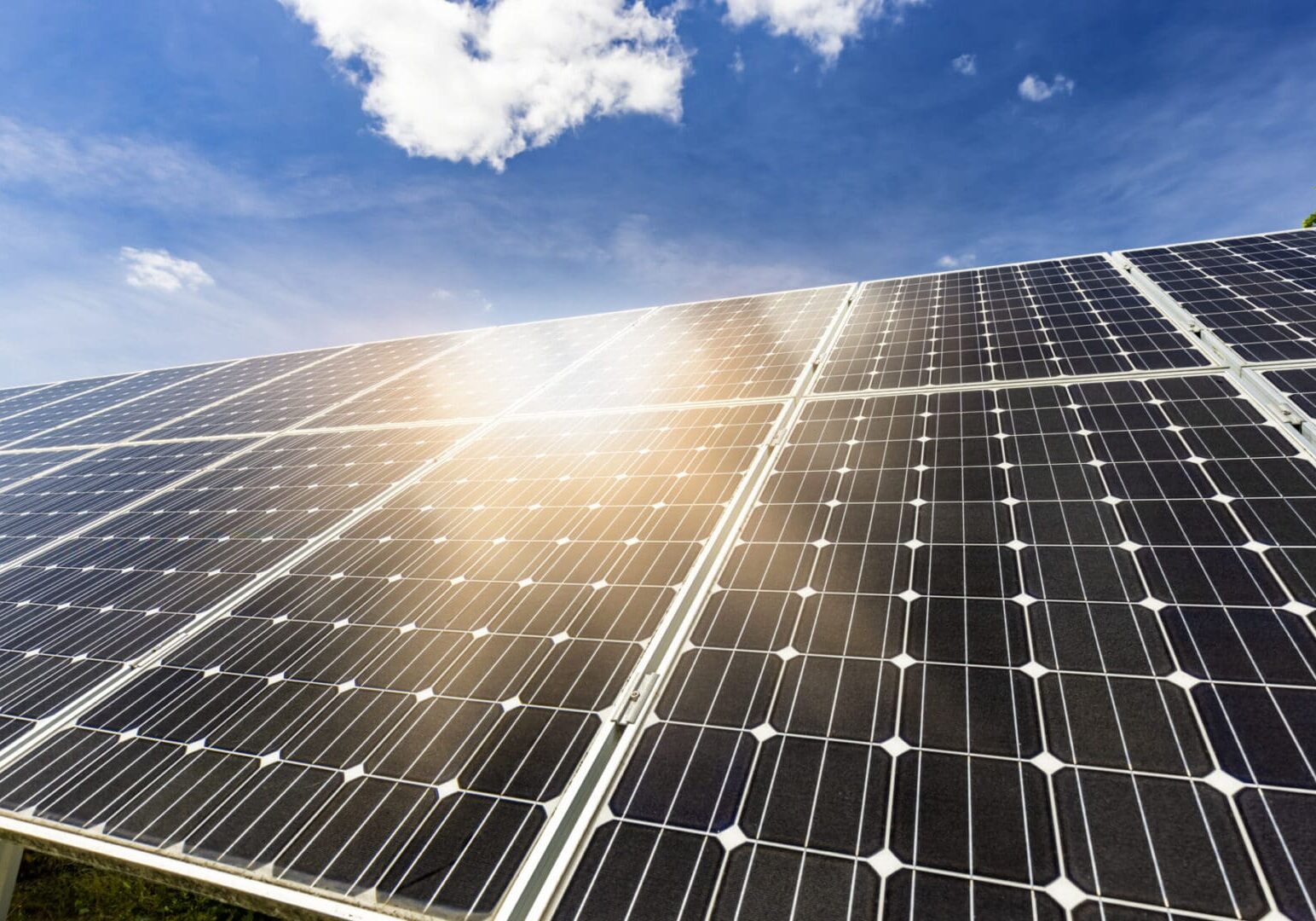 Solar panels absorbing sunlight under a bright sky.
