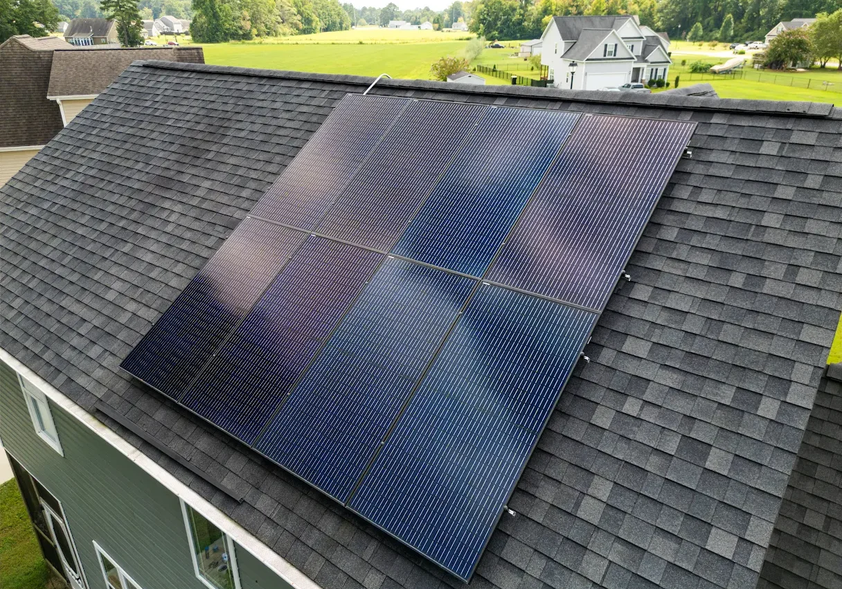 Solar panels installed on a residential roof on a sunny day.